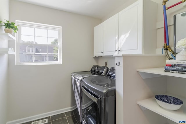 324 NW 8th St, Charlottesville, VA 22903 - washroom featuring separate washer and dryer, cabinet space, and dark tile patterned floors