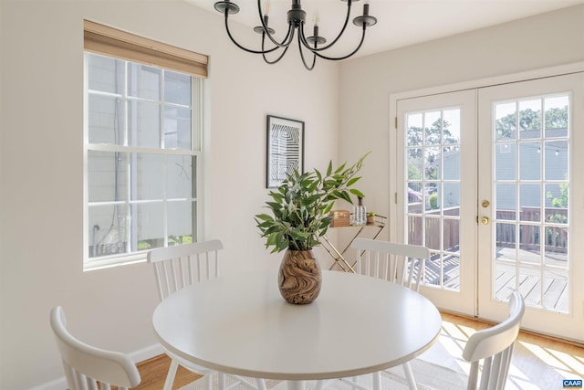 324 NW 8th St, Charlottesville, VA 22903 - dining area featuring plenty of natural light, a chandelier, wood finished floors, and french doors