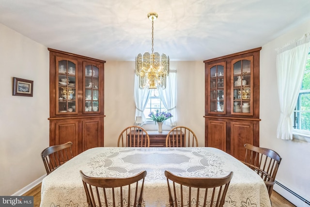 604 Big Oak Rd, Yardley, PA 19067 - dining area featuring a baseboard radiator, a chandelier, and wood finished floors