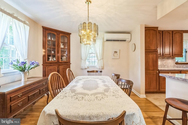 604 Big Oak Rd, Yardley, PA 19067 - dining area featuring an AC wall unit, a chandelier, and light wood-style floors
