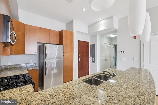 1209 N Charles St Unit 409, Baltimore, MD 21201 - kitchen featuring appliances with stainless steel finishes, light stone counters, recessed lighting, and brown cabinets