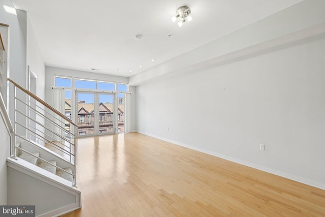 1209 N Charles St Unit 409, Baltimore, MD 21201 - empty room featuring stairway, wood finished floors, and french doors
