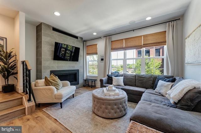 11237 Beaker St, Reston, VA 20190 - living room with wood finished floors, recessed lighting, and a tile fireplace