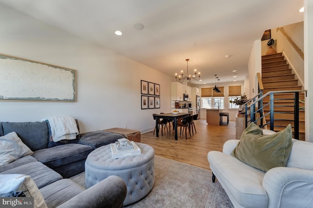 11237 Beaker St, Reston, VA 20190 - living room featuring a chandelier, recessed lighting, stairway, and light wood finished floors