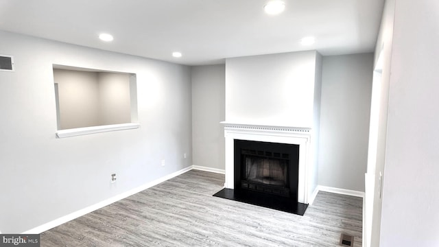 54 Liborio Ln, New Castle, DE 19720 - unfurnished living room with wood finished floors, recessed lighting, and a fireplace