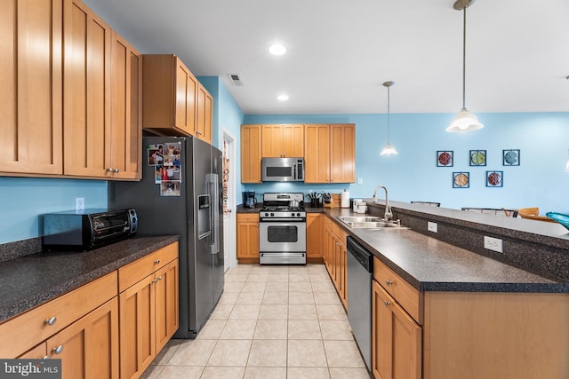 37166 Gull Watch Way Unit 1315, Selbyville, DE 19975 - kitchen with stainless steel appliances, a peninsula, dark countertops, light tile patterned flooring, and pendant lighting