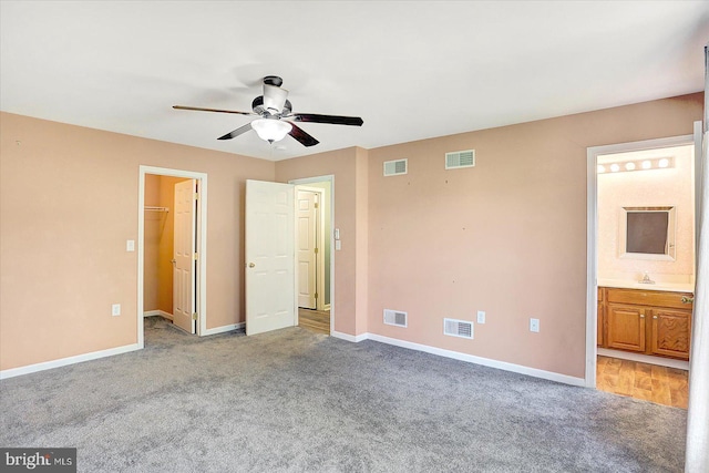 60 Joan Dr, York, PA 17404 - unfurnished bedroom with light colored carpet, ensuite bath, a walk in closet, and a ceiling fan