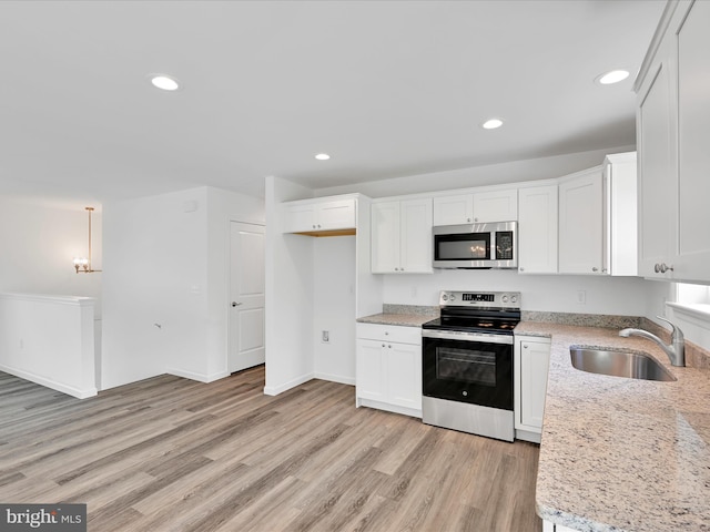 566 Monocacy Trl, Spring Grove, PA 17362 - kitchen featuring stainless steel appliances, light wood-type flooring, recessed lighting, white cabinets, and light stone countertops