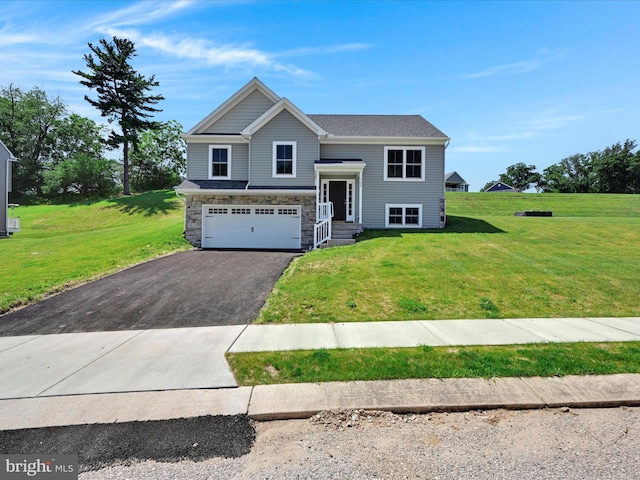 566 Monocacy Trl, Spring Grove, PA 17362 - split foyer home with asphalt driveway, an attached garage, a front yard, and stone siding