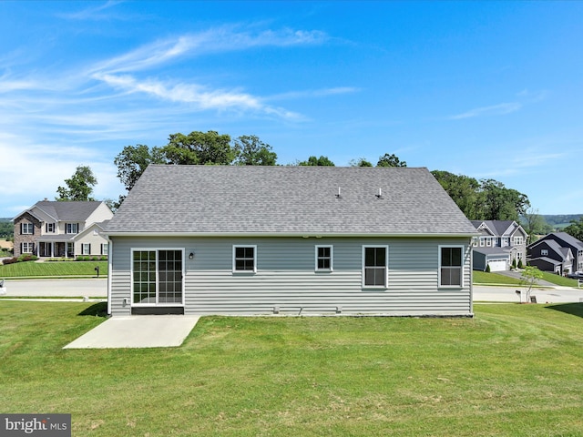 566 Monocacy Trl, Spring Grove, PA 17362 - back of property featuring a patio area, a lawn, a residential view, and roof with shingles