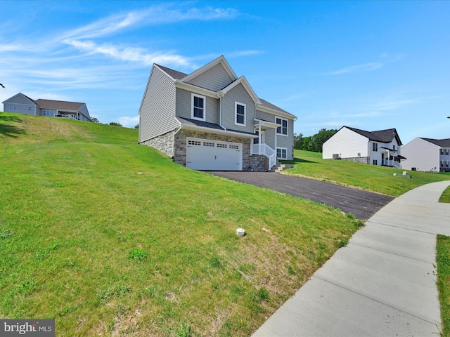 566 Monocacy Trl, Spring Grove, PA 17362 - view of side of home with stone siding, driveway, a garage, and a yard