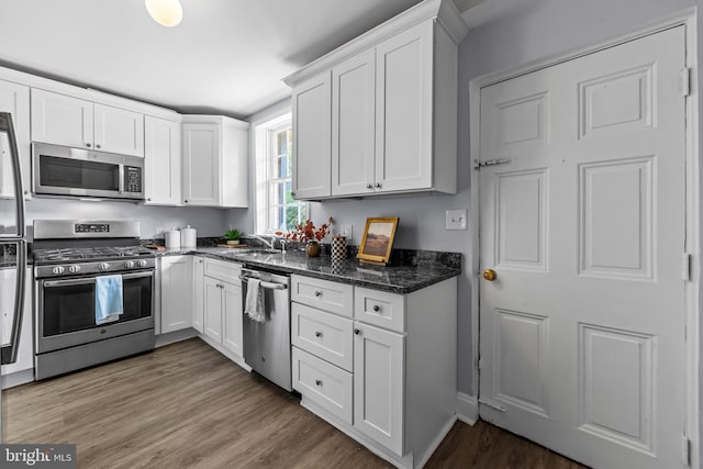 239 W Lafayette Ave, Baltimore, MD 21217 - kitchen with appliances with stainless steel finishes, white cabinets, and wood finished floors