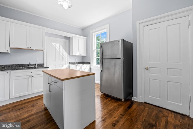239 W Lafayette Ave, Baltimore, MD 21217 - kitchen featuring freestanding refrigerator, dark wood finished floors, white cabinetry, and dark countertops