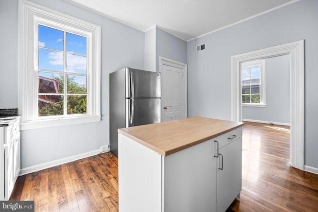 239 W Lafayette Ave, Baltimore, MD 21217 - kitchen with freestanding refrigerator, butcher block counters, dark wood finished floors, ornamental molding, and white cabinetry