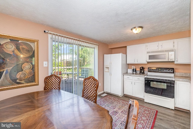 845 Angel Valley Ct, Edgewood, MD 21040 - kitchen featuring white appliances, light countertops, wood finished floors, white cabinetry, and a textured ceiling
