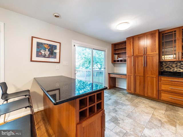 14901 Joshua Tree Rd, North Potomac, MD 20878 - kitchen featuring brown cabinetry, open shelves, built in study area, backsplash, and a peninsula