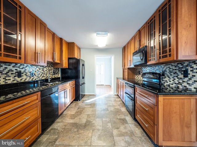 14901 Joshua Tree Rd, North Potomac, MD 20878 - kitchen with black appliances, glass insert cabinets, decorative backsplash, stone finish floors, and brown cabinets