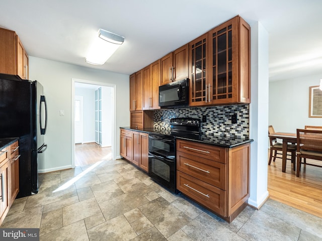 14901 Joshua Tree Rd, North Potomac, MD 20878 - kitchen with black appliances, decorative backsplash, glass insert cabinets, brown cabinets, and stone finish floors