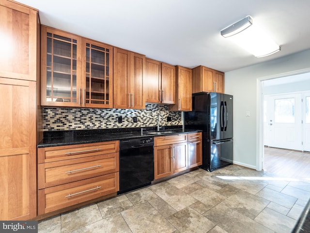 14901 Joshua Tree Rd, North Potomac, MD 20878 - kitchen with black appliances, tasteful backsplash, brown cabinets, glass insert cabinets, and light stone finish floors