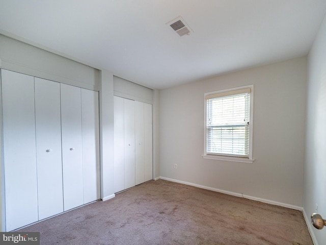 14901 Joshua Tree Rd, North Potomac, MD 20878 - unfurnished bedroom with two closets and carpet flooring