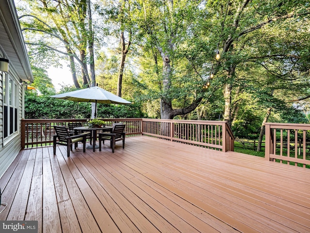 14901 Joshua Tree Rd, North Potomac, MD 20878 - wooden deck featuring outdoor dining space and view of scattered trees