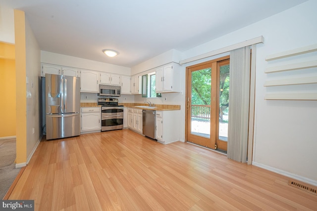 1368 Abbey Way, Bensalem, PA 19020 - kitchen featuring appliances with stainless steel finishes, light wood finished floors, white cabinetry, and light countertops