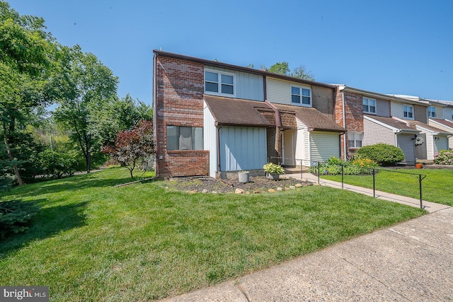 1368 Abbey Way, Bensalem, PA 19020 - view of property featuring a front lawn, brick siding, board and batten siding, and a shingled roof