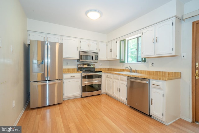1368 Abbey Way, Bensalem, PA 19020 - kitchen with appliances with stainless steel finishes, white cabinetry, light wood finished floors, and light countertops