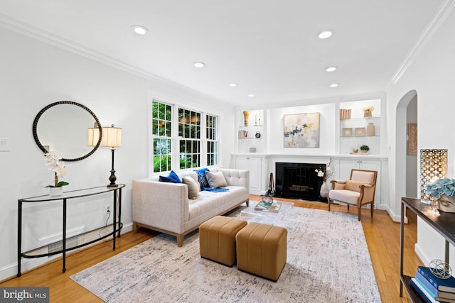 2723 Washington Ave, Chevy Chase, MD 20815 - living area featuring ornamental molding, arched walkways, wood finished floors, recessed lighting, and a fireplace with flush hearth