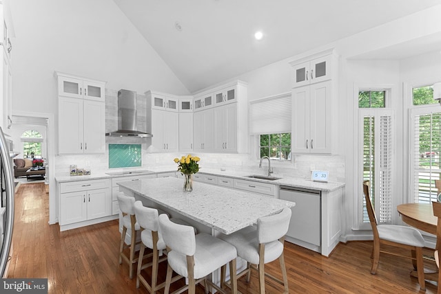10111 Ballynahown Cir, Fairfax, VA 22030 - kitchen featuring wall chimney range hood, dishwasher, white cabinetry, backsplash, and dark wood finished floors