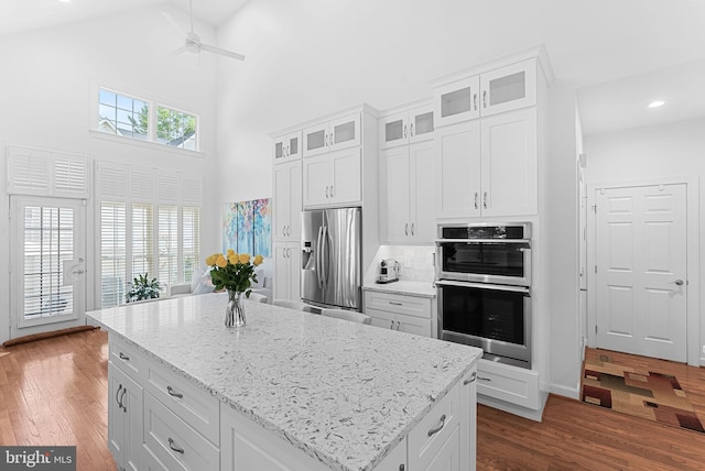 10111 Ballynahown Cir, Fairfax, VA 22030 - kitchen with stainless steel appliances, a high ceiling, ceiling fan, dark wood-type flooring, and white cabinets