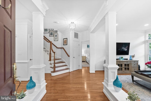 10111 Ballynahown Cir, Fairfax, VA 22030 - entrance foyer with wood finished floors, stairs, ornate columns, crown molding, and a chandelier