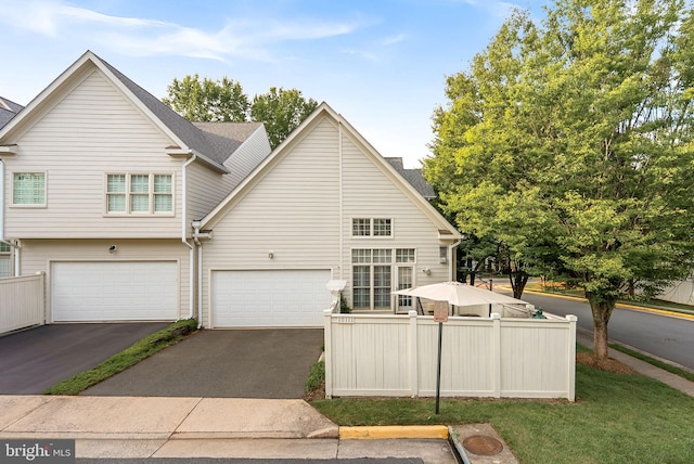 10111 Ballynahown Cir, Fairfax, VA 22030 - back of house with driveway and an attached garage
