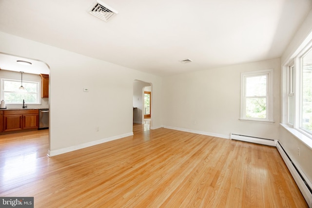 860 Temple Rd, Pottstown, PA 19465 - unfurnished room with a baseboard heating unit, arched walkways, a baseboard radiator, and light wood-type flooring