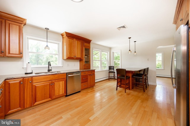 860 Temple Rd, Pottstown, PA 19465 - kitchen featuring stainless steel appliances, brown cabinets, light wood-type flooring, a kitchen breakfast bar, and hanging light fixtures