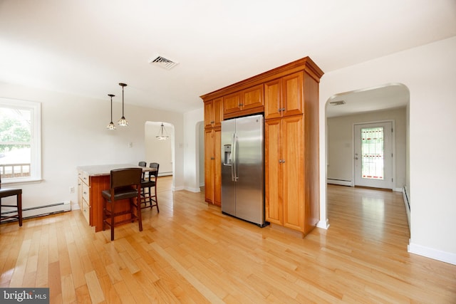 860 Temple Rd, Pottstown, PA 19465 - kitchen featuring stainless steel fridge with ice dispenser, arched walkways, a baseboard heating unit, and light wood-style floors
