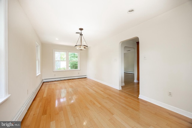 860 Temple Rd, Pottstown, PA 19465 - spare room with a baseboard radiator, arched walkways, light wood-type flooring, a baseboard heating unit, and a chandelier
