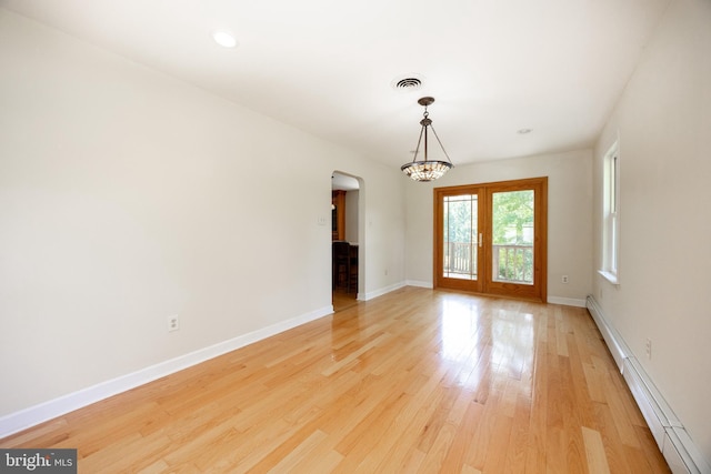 860 Temple Rd, Pottstown, PA 19465 - empty room with arched walkways, a baseboard heating unit, light wood finished floors, a chandelier, and recessed lighting
