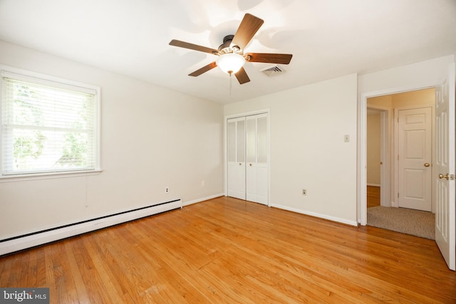 860 Temple Rd, Pottstown, PA 19465 - unfurnished bedroom with a baseboard heating unit, light wood finished floors, a closet, and a ceiling fan