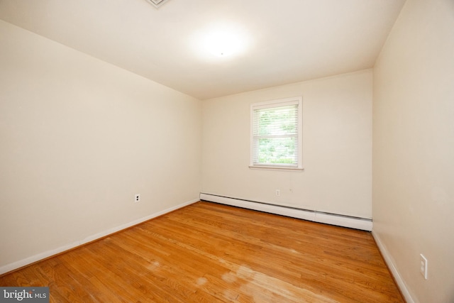 860 Temple Rd, Pottstown, PA 19465 - empty room with a baseboard heating unit and wood finished floors