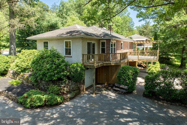 860 Temple Rd, Pottstown, PA 19465 - view of front facade with a deck, stucco siding, roof with shingles, and stairway