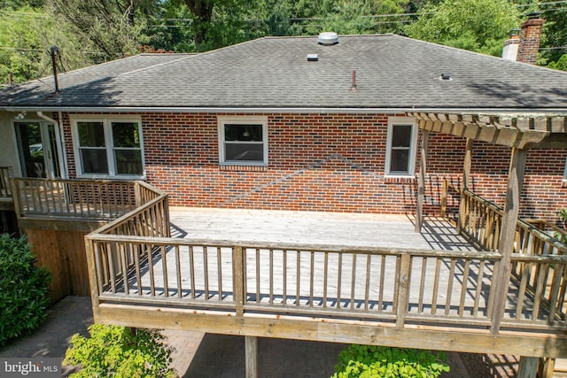 860 Temple Rd, Pottstown, PA 19465 - rear view of property featuring a shingled roof, brick siding, a wooden deck, and a chimney