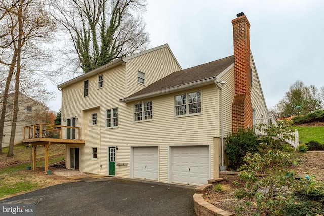 5 Charcoal Ln, Mohnton, PA 19540 - back of property with a garage, asphalt driveway, a deck, and a chimney