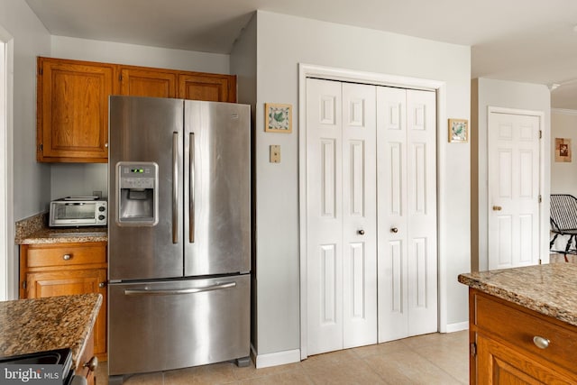 5 Charcoal Ln, Mohnton, PA 19540 - kitchen with stainless steel refrigerator with ice dispenser, brown cabinetry, stone counters, and light tile patterned flooring