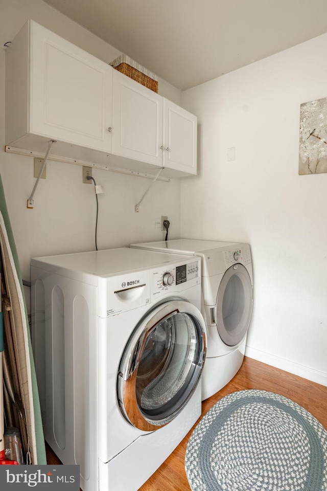 5 Charcoal Ln, Mohnton, PA 19540 - laundry area featuring cabinet space, independent washer and dryer, and light wood finished floors
