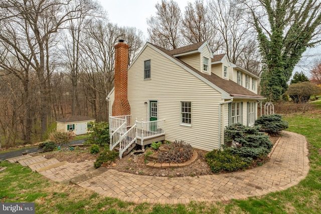 5 Charcoal Ln, Mohnton, PA 19540 - view of property exterior with a chimney, a shingled roof, and a storage shed