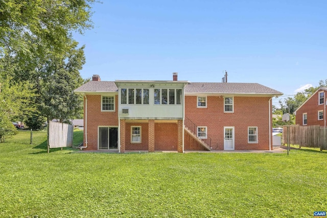 608 Davis Ave, Charlottesville, VA 22901 - back of property featuring a sunroom, brick siding, a chimney, and stairway