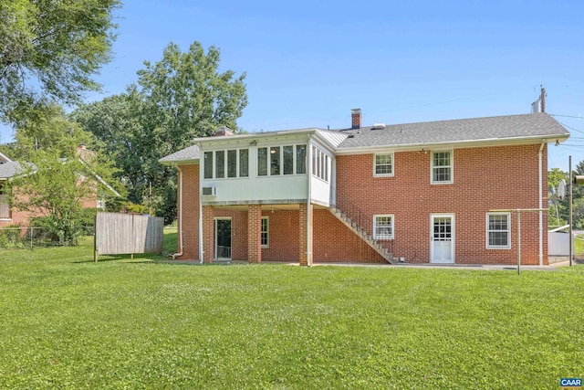 608 Davis Ave, Charlottesville, VA 22901 - rear view of house featuring a sunroom, brick siding, a yard, and a chimney