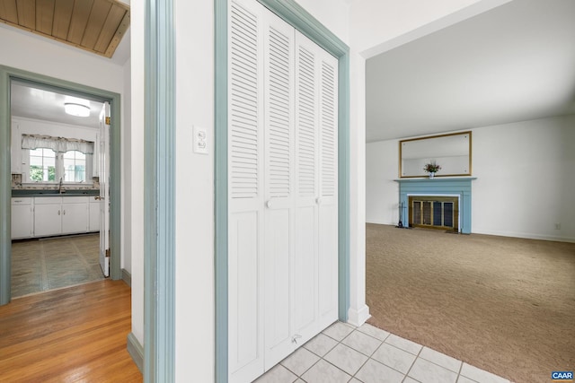 608 Davis Ave, Charlottesville, VA 22901 - hallway with light carpet and light tile patterned floors