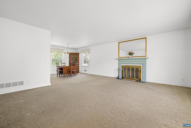 608 Davis Ave, Charlottesville, VA 22901 - unfurnished living room with a chandelier, carpet flooring, and a fireplace with flush hearth